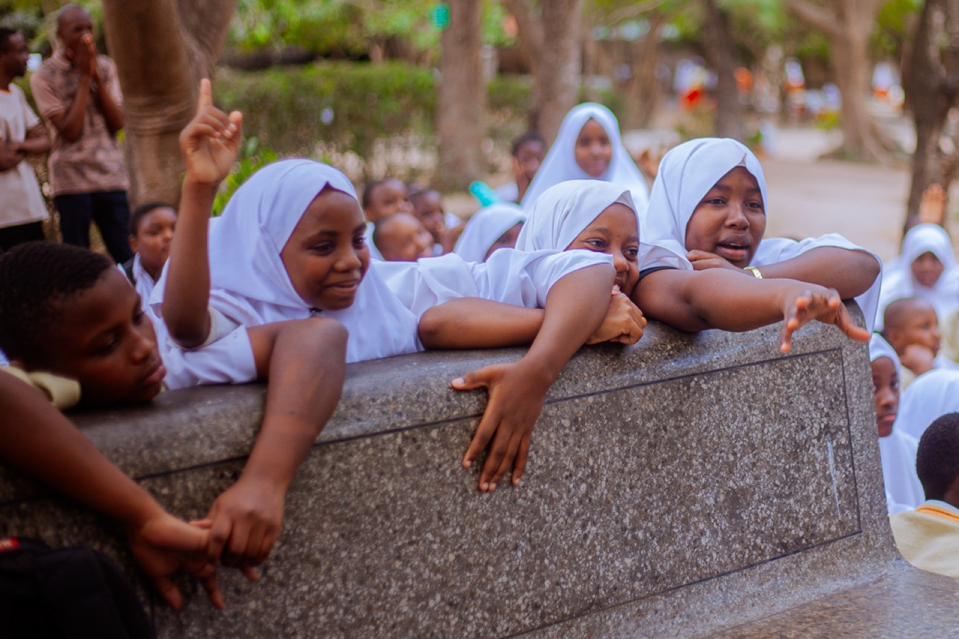 Students lean in, reaching and pointing with excitement during the session