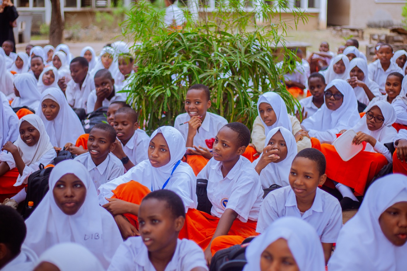 A large group of students gathered outdoors for the outreach session