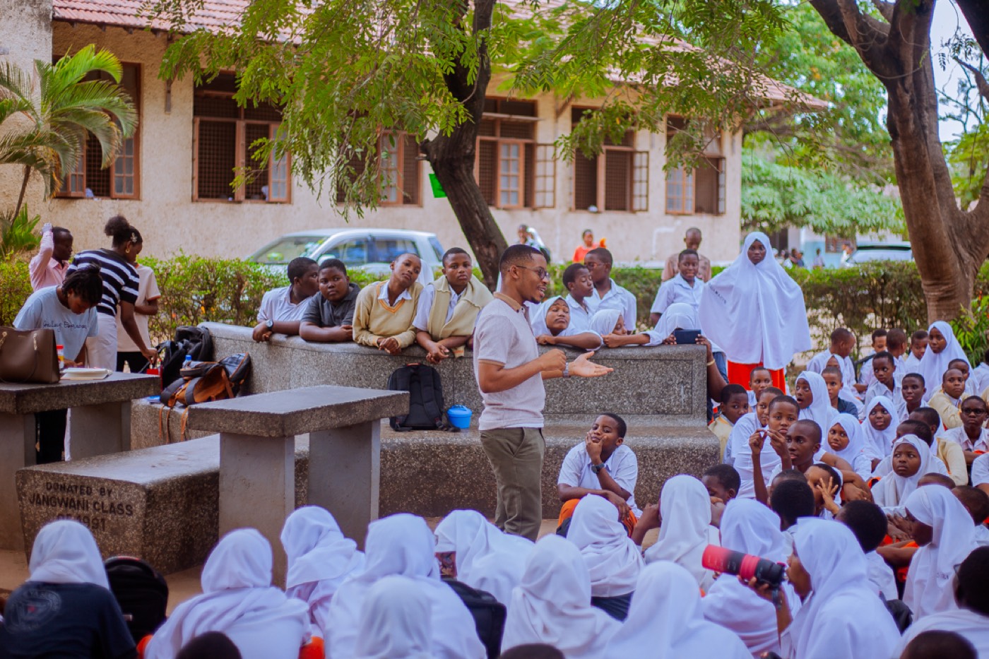 A GROW educator addresses students seated around him