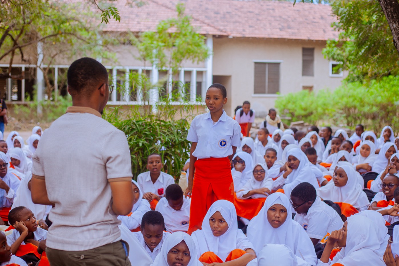 A student stands to respond to a GROW educator during the discussion