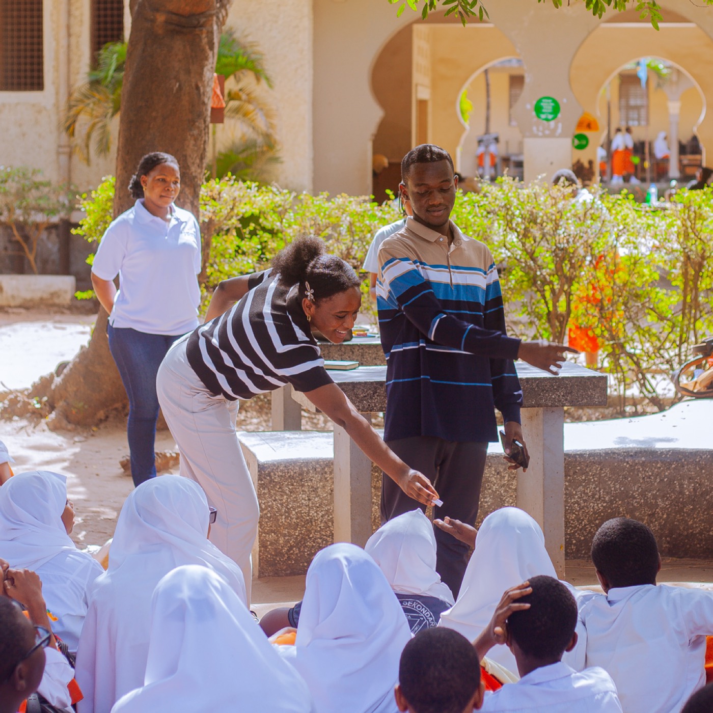 GROW team members hand out materials to students