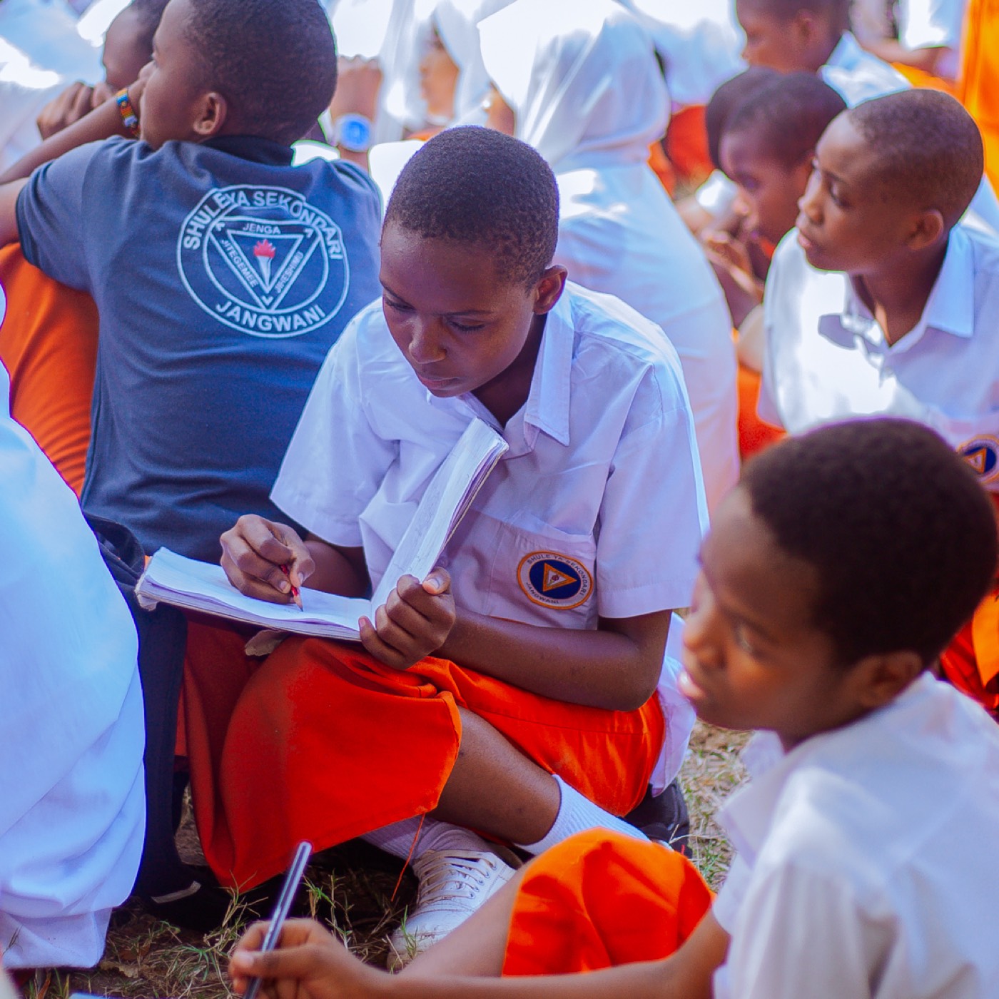 A Jangwani Secondary School student writes in his notebook