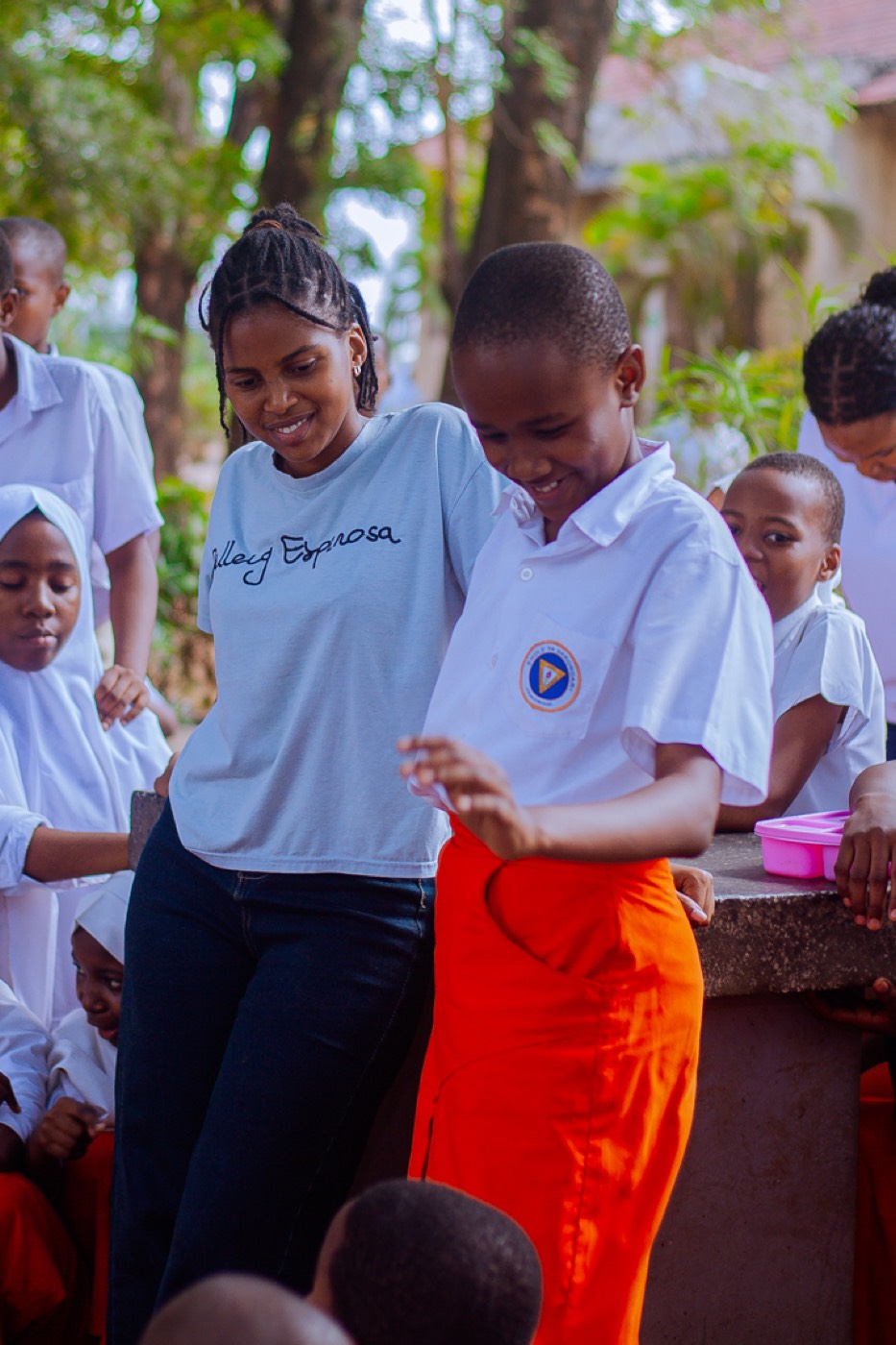 A GROW team member shares a playful moment with a student