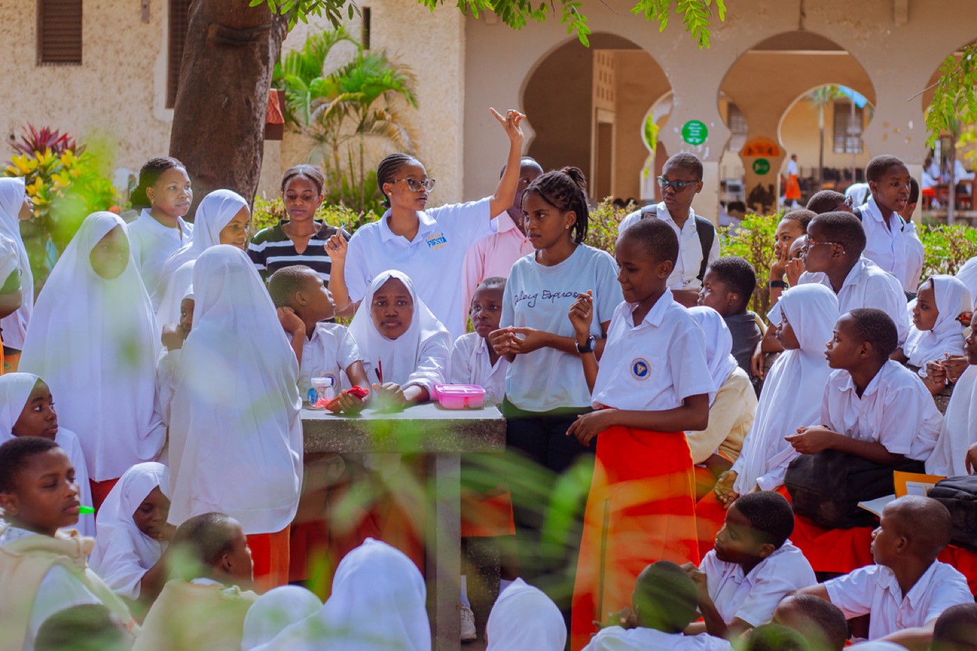 A GROW team member raises a hand as students respond during the session