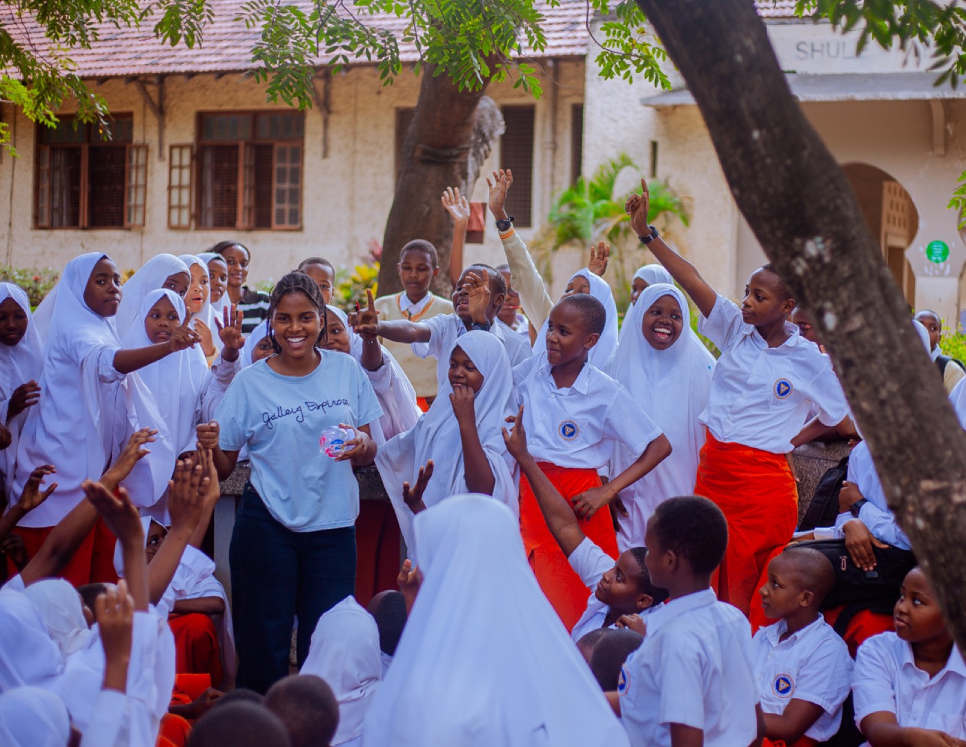 Students cheer with hands raised during the outreach